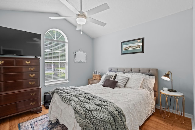 bedroom with wood finished floors, vaulted ceiling, and a ceiling fan