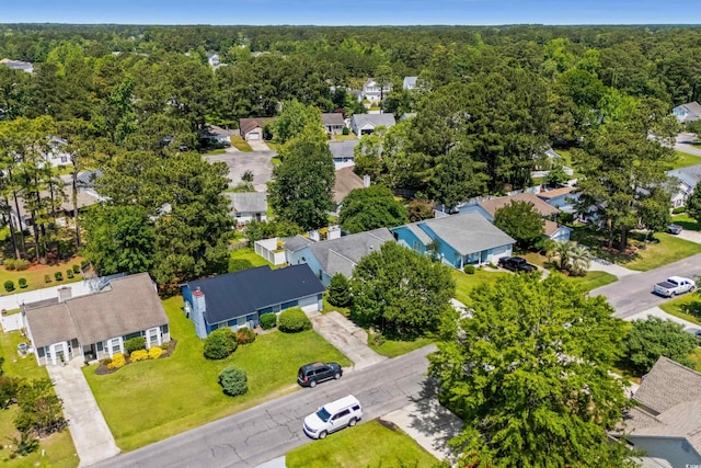 aerial perspective of suburban area with a forest