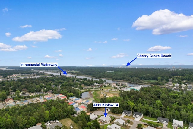 bird's eye view of a nearby body of water and a forest