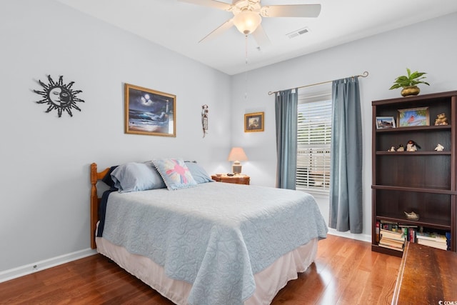 bedroom with wood finished floors, baseboards, and ceiling fan