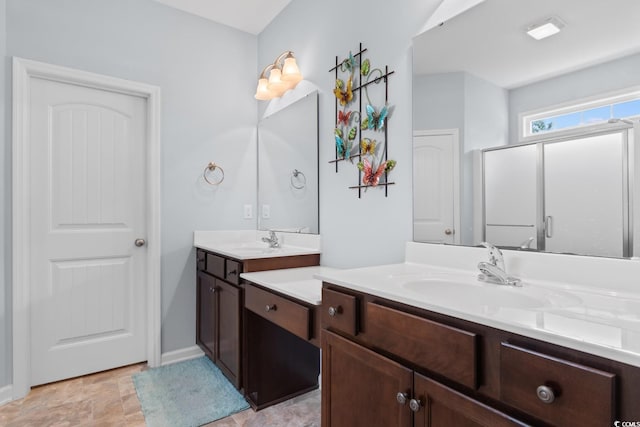 bathroom with vanity, baseboards, and stone finish flooring