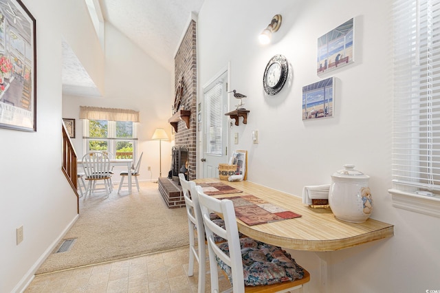 2191 Liberty Cir, Little River, SC 29566 - dining area with a brick fireplace, baseboards, and high vaulted ceiling