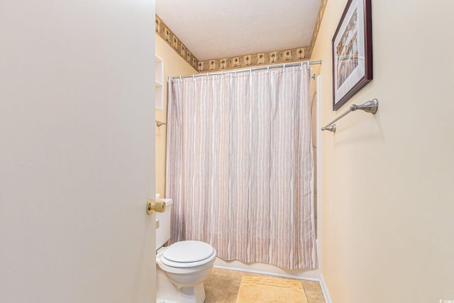 2191 Liberty Cir, Little River, SC 29566 - bathroom with toilet, tile patterned floors, a textured ceiling, and shower / bath combination with curtain