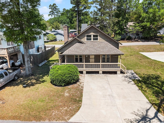 2191 Liberty Cir, Little River, SC 29566 - view of front of property with a porch, a shingled roof, and a front yard