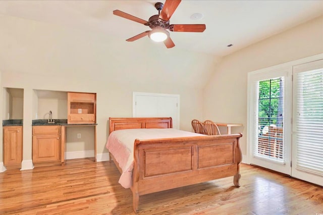 79 Windsor Cir SW, Ocean Isle Beach, NC 28469 - bedroom with vaulted ceiling, light wood-type flooring, access to exterior, a sink, and a ceiling fan