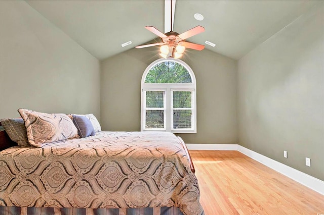79 Windsor Cir SW, Ocean Isle Beach, NC 28469 - bedroom featuring lofted ceiling, wood finished floors, baseboards, and a ceiling fan
