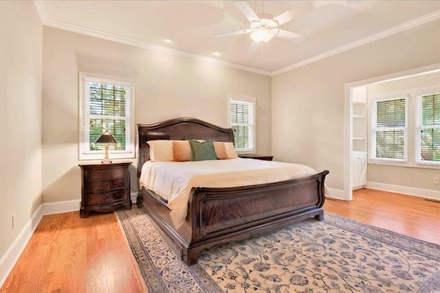79 Windsor Cir SW, Ocean Isle Beach, NC 28469 - bedroom featuring light wood-style floors, multiple windows, ornamental molding, and baseboards