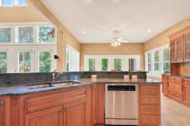 79 Windsor Cir SW, Ocean Isle Beach, NC 28469 - kitchen with dishwasher, a sink, ceiling fan, light tile patterned floors, and brown cabinetry