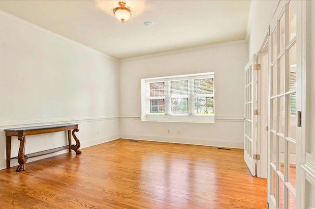 79 Windsor Cir SW, Ocean Isle Beach, NC 28469 - spare room featuring wood finished floors, ornamental molding, french doors, and baseboards