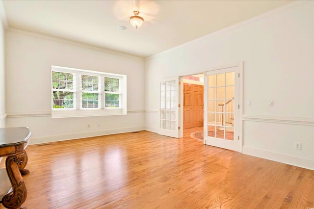79 Windsor Cir SW, Ocean Isle Beach, NC 28469 - empty room featuring ornamental molding, french doors, light wood finished floors, and baseboards