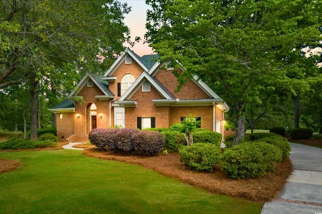 79 Windsor Cir SW, Ocean Isle Beach, NC 28469 - view of front of property featuring brick siding and a front yard