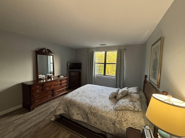 5001 Little River Rd Unit E-306, Myrtle Beach, SC 29577 - bedroom with dark wood-style floors and baseboards