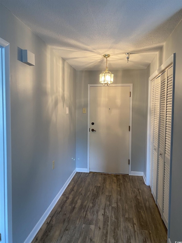 5001 Little River Rd Unit E-306, Myrtle Beach, SC 29577 - doorway with dark wood-style flooring, a textured ceiling, baseboards, and a chandelier