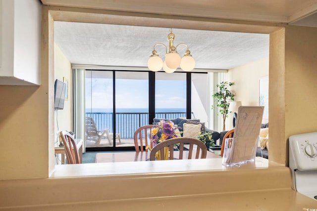 2511 S Ocean Blvd S Unit 1802B, Myrtle Beach, SC 29577 - dining room featuring expansive windows, a chandelier, and a textured ceiling
