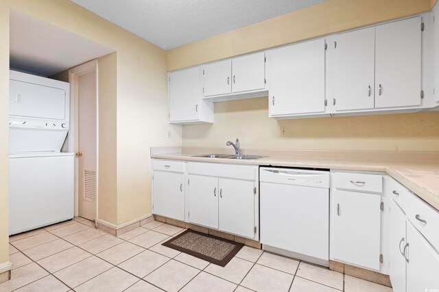 2511 S Ocean Blvd S Unit 1802B, Myrtle Beach, SC 29577 - kitchen with dishwasher, a sink, stacked washer and clothes dryer, baseboards, and light countertops
