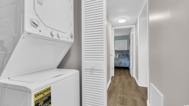 9501 Shore Dr Unit A-211, Myrtle Beach, SC 29572 - laundry room featuring stacked washer / dryer, wood finished floors, and baseboards