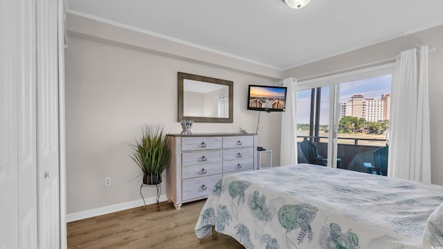 9501 Shore Dr Unit A-211, Myrtle Beach, SC 29572 - bedroom with access to exterior, wood finished floors, baseboards, and crown molding