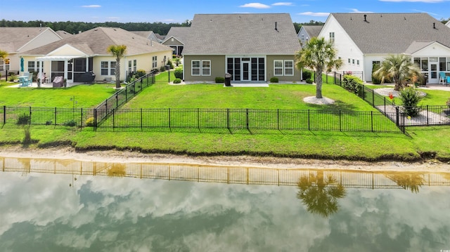 rear view of house with a water view and a residential view
