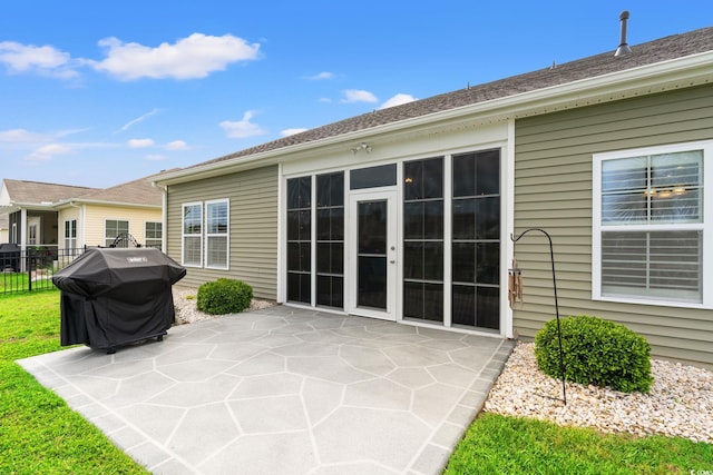 back of property featuring a patio and fence