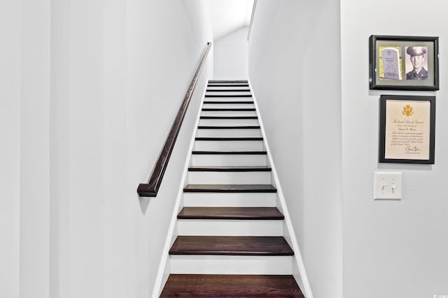 stairway with baseboards and wood finished floors