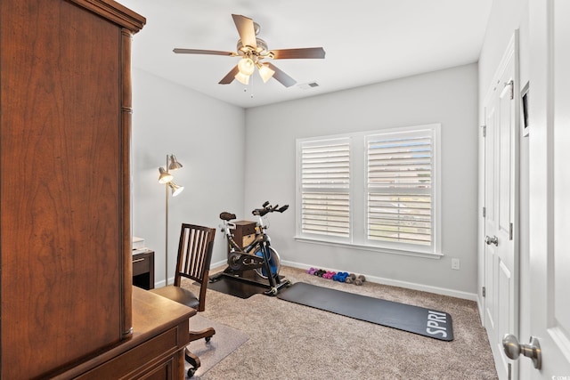 exercise area featuring ceiling fan, carpet flooring, and baseboards