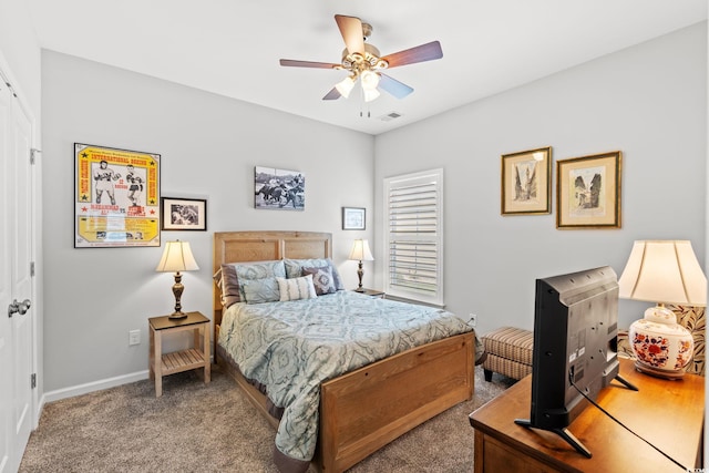 carpeted bedroom featuring baseboards and ceiling fan