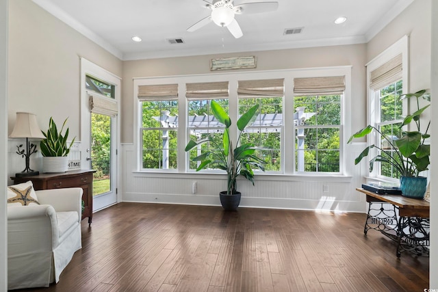 sitting room with ceiling fan, dark wood-type flooring, recessed lighting, and ornamental molding
