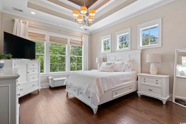 bedroom featuring multiple windows, dark wood finished floors, a raised ceiling, a chandelier, and recessed lighting
