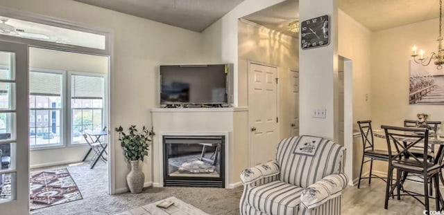 9780 Leyland Dr Unit 112, Myrtle Beach, SC 29572 - living area with a glass covered fireplace, a chandelier, baseboards, and carpet flooring