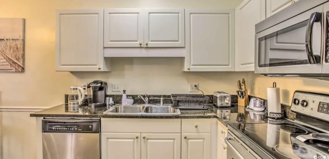 9780 Leyland Dr Unit 112, Myrtle Beach, SC 29572 - kitchen with appliances with stainless steel finishes, a sink, dark countertops, and white cabinetry