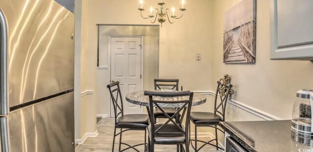 9780 Leyland Dr Unit 112, Myrtle Beach, SC 29572 - dining room with a chandelier and light wood finished floors