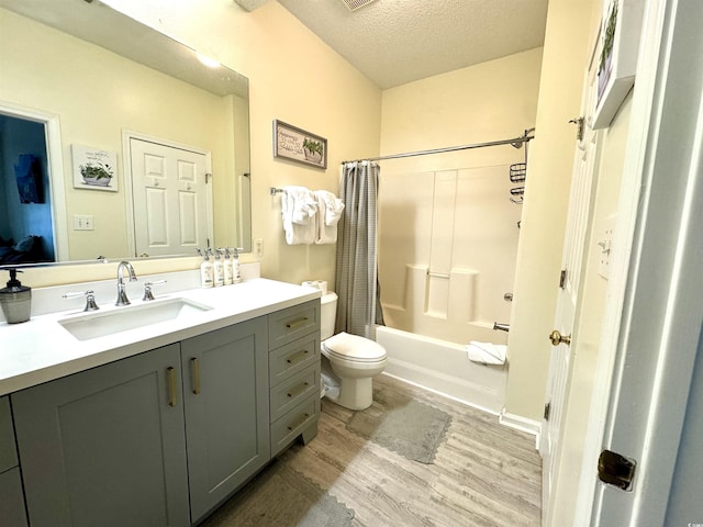 9780 Leyland Dr Unit 112, Myrtle Beach, SC 29572 - full bath featuring wood finished floors, a textured ceiling, toilet, vanity, and shower / tub combo