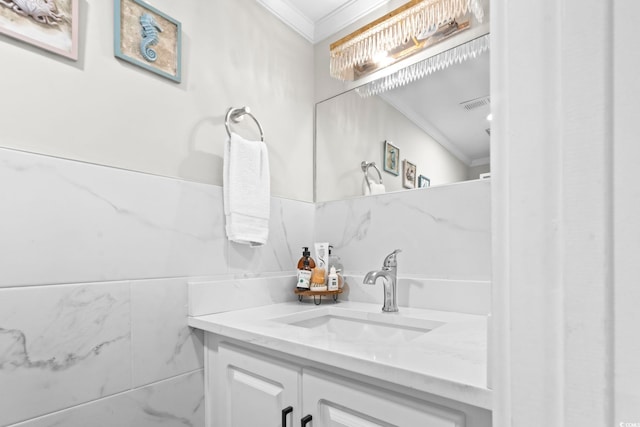 bathroom with ornamental molding and vanity