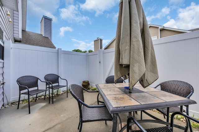 503 20th Ave N Unit 46B, North Myrtle Beach, SC 29582 - view of patio with a fenced backyard and outdoor dining area