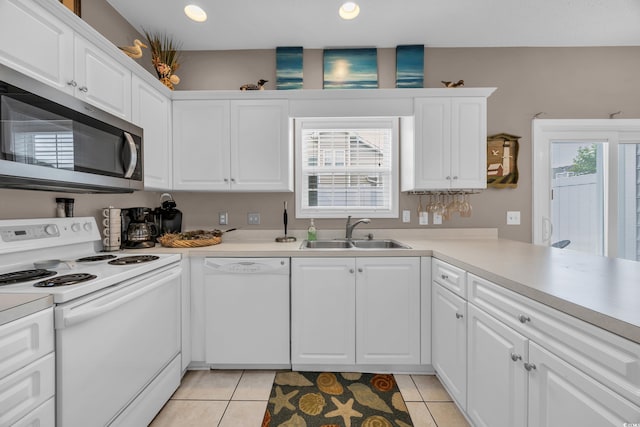 503 20th Ave N Unit 46B, North Myrtle Beach, SC 29582 - kitchen featuring white appliances, a sink, white cabinets, light countertops, and light tile patterned floors