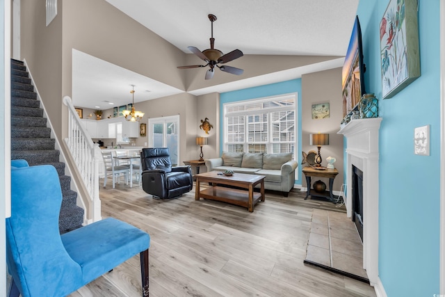 503 20th Ave N Unit 46B, North Myrtle Beach, SC 29582 - living room featuring stairway, vaulted ceiling, a ceiling fan, light wood-type flooring, and a fireplace