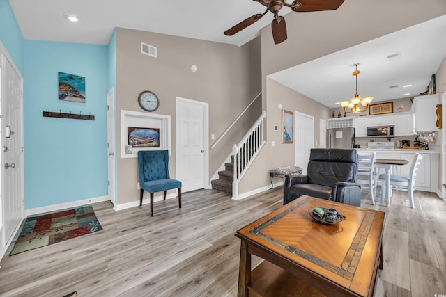 503 20th Ave N Unit 46B, North Myrtle Beach, SC 29582 - living room with high vaulted ceiling, a chandelier, ceiling fan, stairs, and light wood-type flooring