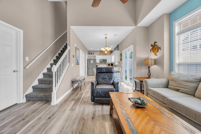 503 20th Ave N Unit 46B, North Myrtle Beach, SC 29582 - living room with stairway, light wood-style floors, a chandelier, baseboards, and ceiling fan