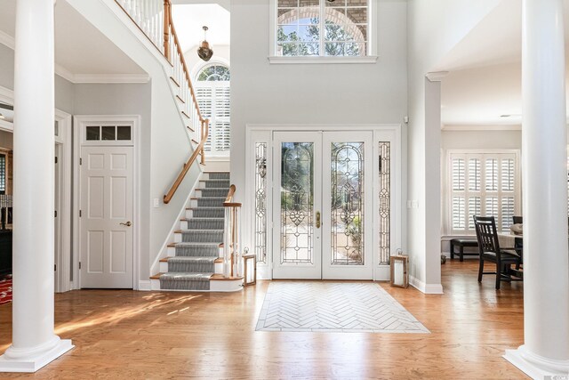 78 Oakmont Dr, Pawleys Island, SC 29585 - foyer entrance featuring ornate columns, stairs, wood finished floors, ornamental molding, and french doors