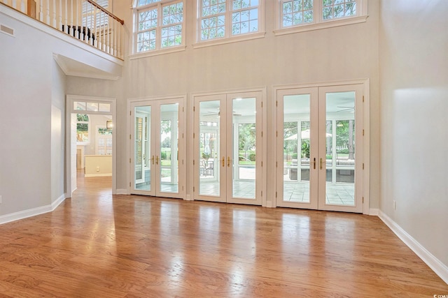 78 Oakmont Dr, Pawleys Island, SC 29585 - doorway with french doors, a high ceiling, plenty of natural light, wood finished floors, and baseboards