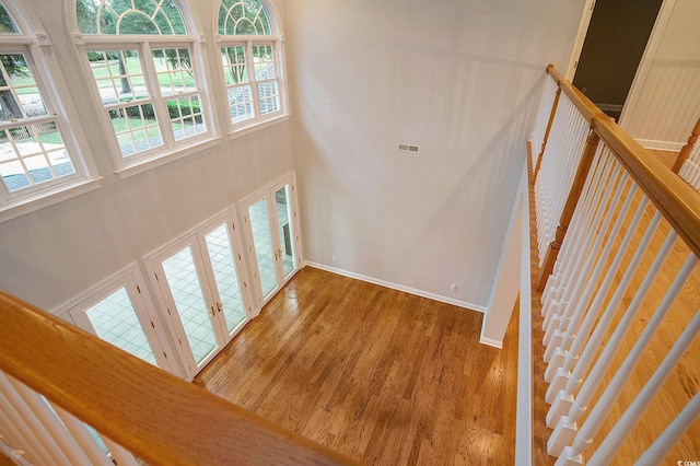 78 Oakmont Dr, Pawleys Island, SC 29585 - stairs with a towering ceiling, wood finished floors, french doors, and baseboards