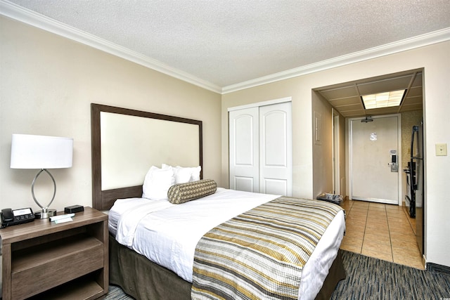 1105 S Ocean Blvd Unit 1144, Myrtle Beach, SC 29577 - bedroom featuring a closet, crown molding, tile patterned floors, and a textured ceiling