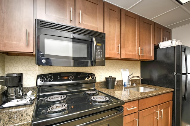 1105 S Ocean Blvd Unit 1144, Myrtle Beach, SC 29577 - kitchen featuring black appliances, a sink, and brown cabinets