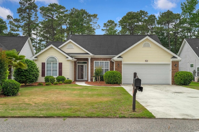 view of front of property with an attached garage, concrete driveway, brick siding, and a front yard