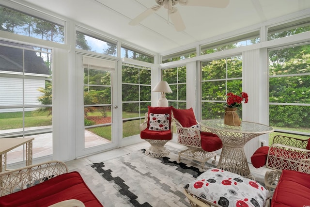 sunroom with ceiling fan, healthy amount of natural light, and tile patterned floors
