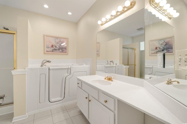 full bathroom with tile patterned flooring, a stall shower, a garden tub, vanity, and recessed lighting