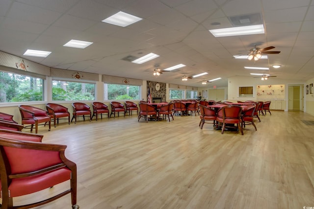 dining area with wood finished floors, vaulted ceiling, and ceiling fan