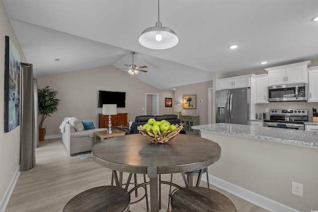 1307 Collins Park St, Conway, SC 29526 - kitchen with stainless steel appliances, light wood-type flooring, white cabinetry, baseboards, and lofted ceiling
