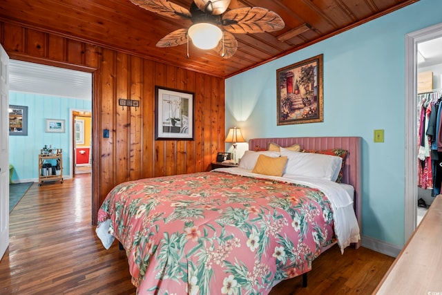 bedroom featuring wood finished floors, baseboards, wooden ceiling, wooden walls, and ornamental molding