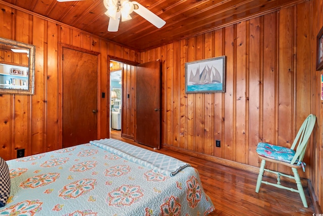 bedroom featuring wooden walls, wooden ceiling, and hardwood / wood-style flooring